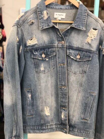 Distressed denim, seen here on a jacket at The Silver Dahlia,  continues to be a popular trend heading into fall. 