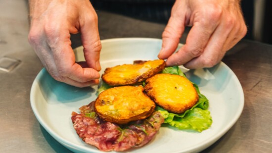 Chef Matthew Bousquet plating a meal