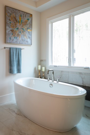 Freestanding soaker tub next to generously-sized walk-in shower.