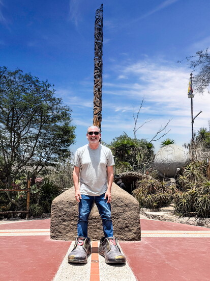 One foot in the Northen hemisphere and the other in the Southern hemisphere.