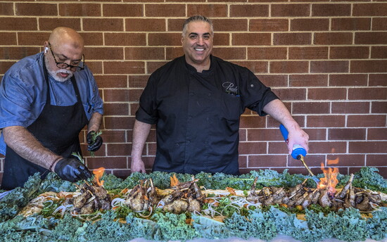 Chef Fami Elabed (right) enjoys creating new food feasts for patrons.