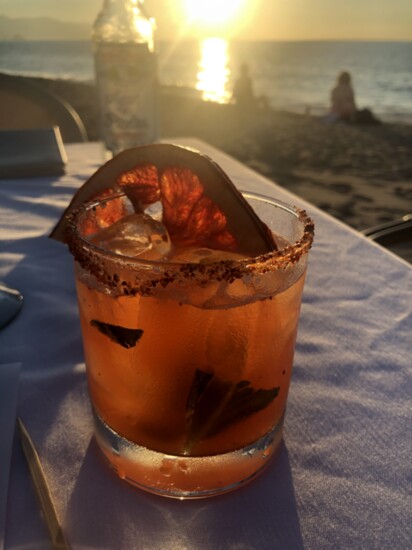 Margarita of the Day at El Dorado, Puerto Vallarta, featuring mezcal and a burnt slice of grapefruit.