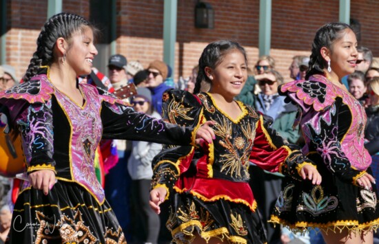 Peruvian dancers parading down Main Street