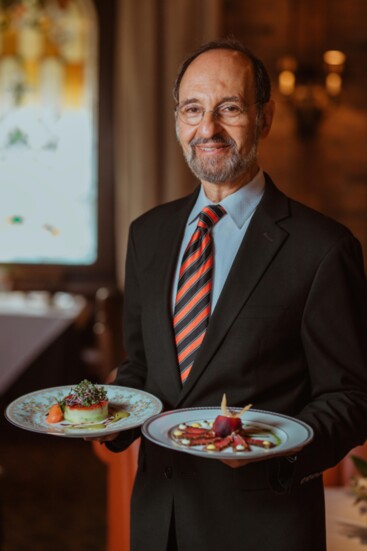 Owner Kamal Boulos holding the Shrimp Gateau (in right hand) and Herb Crusted Sashimi Tuna (in left hand)