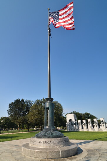 Washington, D.C. U.S. flag with World War II Monument background