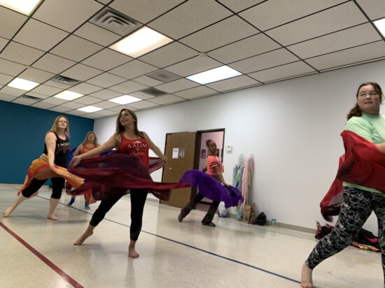 Students at Aalim Dance Academy practice a routine using a veil.