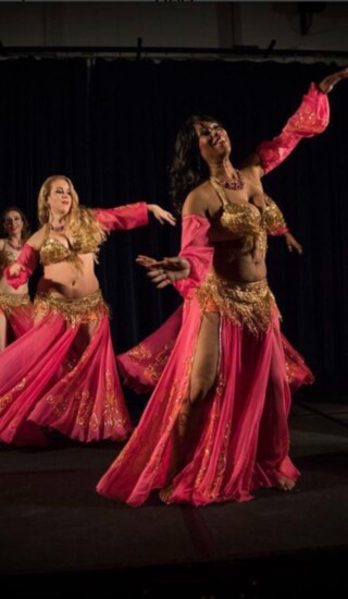 The Aalim Bellydancers perform on stage for the public.
