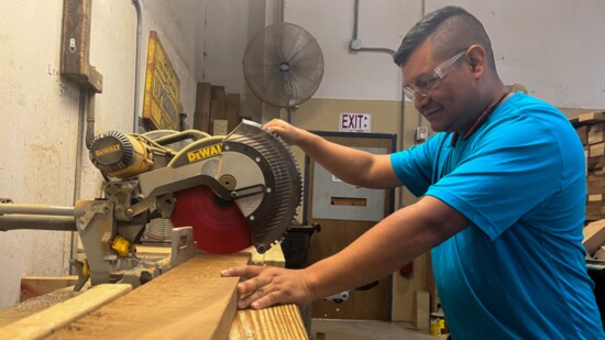 A Better Way resident cuts boards for Chick fil A tables. 