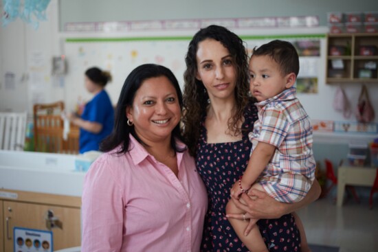 Maria Moreno, director of early childhood education, with a student and her child.