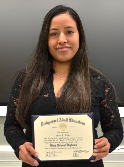 Maria Huisha with her NEDP high school diploma.