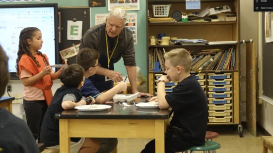 Artist Simon Rigg teaching local students.