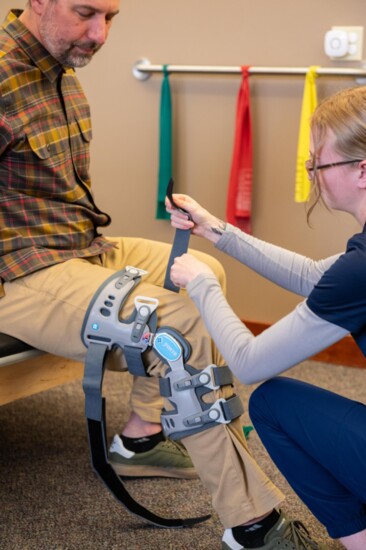 Victoria Bates, APS Rehab Tech, demonstrates treatment techniques and use of equipment on Dr. Jeffery. 