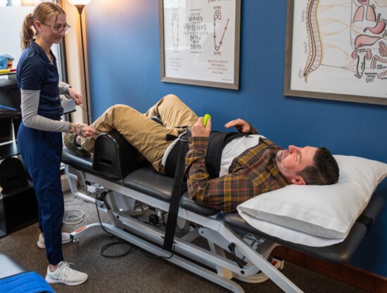 Victoria Bates, APS Rehab Tech, demonstrates treatment techniques and use of equipment on Dr. Jeffery. 