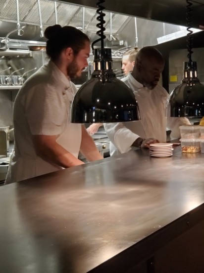 Chef Black (right) and his team prepare the second dish of the evening.