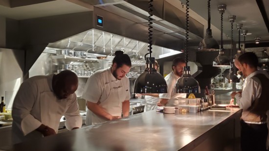 Chef Black (far left) and his team prepare different elements of each dish.