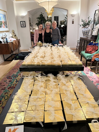 (L-R) Terry , actress Annie Potts and volunteer Paige Peter in Los Angeles preparing boxed cash gifts for families needing assistance 