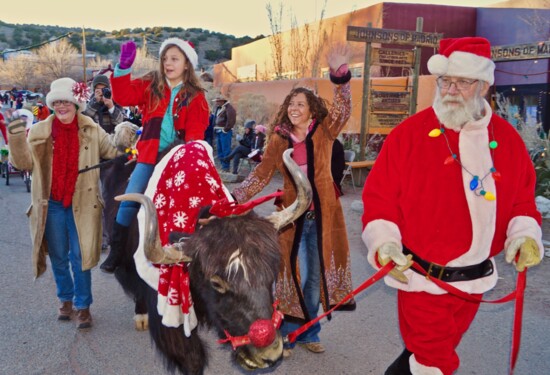 A yak leads the Madrid Christmas parade.