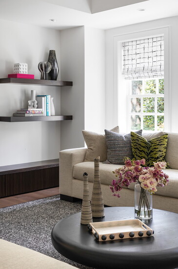 Vases, flowers, and books give a room a lived-in energy without being too personal.