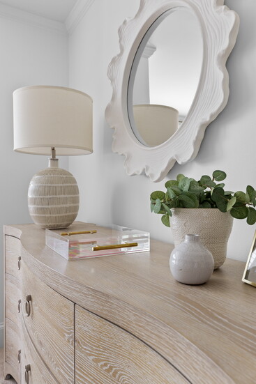 An acrylic tray with patterned inset, neutral ceramics and a fun (but not childish) framed mirror will grow with this lucky girl. 