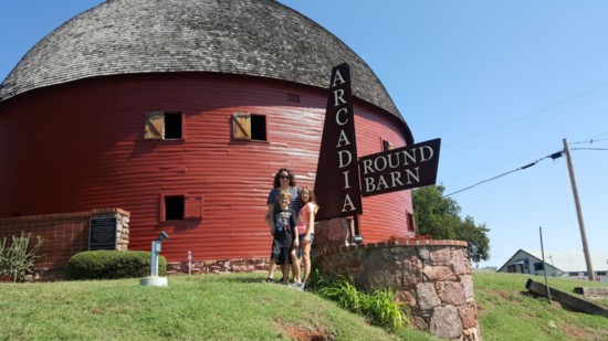 Brooke, Graham, 10, and Murphy, 13, pose in front of the Arcadia Round Barn.