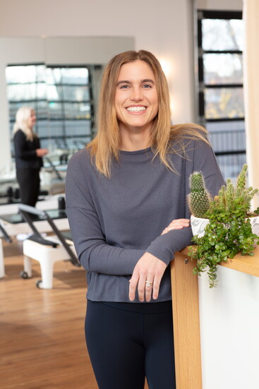 Anna Andrade, the owner of FORM fitness, greets clients as they file into the studio