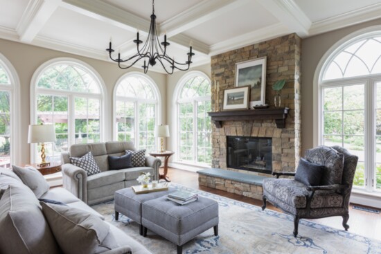 Renovated living room with new windows, coffers, and stone fireplace