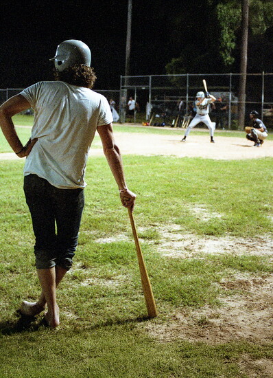 A batter waits on deck at Govalle Park