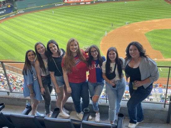 Employees have fun at a Rangers game.