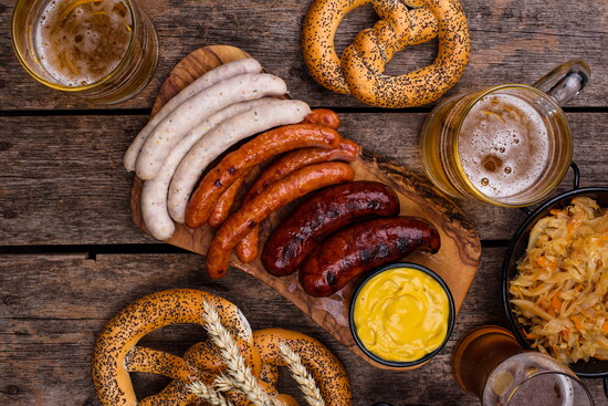 Oktoberfest spread – Traditional German sausages, pretzels, kraut, and frothy beers set the stage for fall festivities.