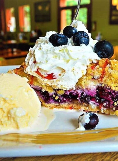 Pie in the Sky – Blueberry pie with whipped cream and ice cream, a house favorite.