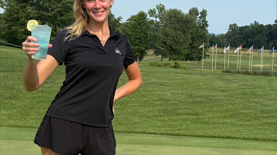 Bartender Valerie Kruger holding the Water Hazard cocktail. Photo Credit: Tonya Wallace