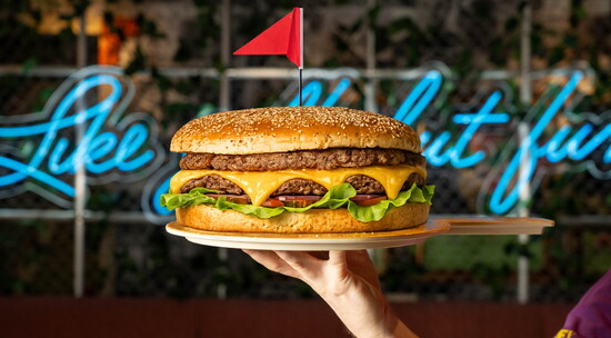 The Giant Burger arrives with a drum roll and enough beefy goodness to share. Photo by FunLab
