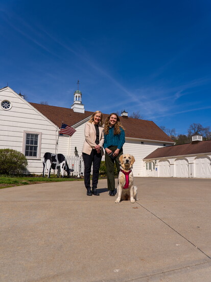 Executive Director Christine Parker & Operations Manager Heather Haught with welcoming pup Samantha.