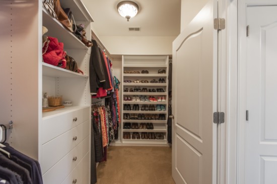 The master bedroom suite features a walk-in closet created by Closets By Design.