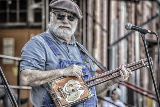 Microwave Dave playing his LowBow cigar box guitar at the Cigar Box Guitar Festival at Lowe Mill in 2022