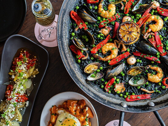 At Aventura, rustic tapas, paella, and craft gin cocktails set the tone. Photo courtesy of The Pulpo Group.
