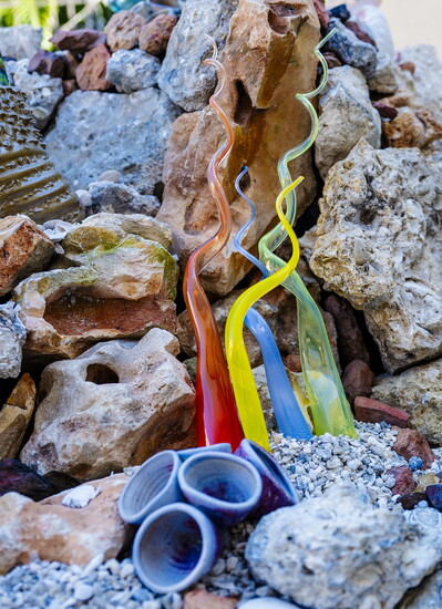 Fossilized rocks, colorful glass-blown seagrass, and ceramic barnacles compose a vivid underwater scene.