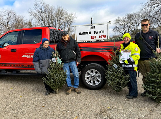 Cathy and Tom Lingo, owners of Excelsior’s Garden Patch, providing trees for the past 15 years with Fire Marshall Kellie Murphy-Ringate and Andy Heim