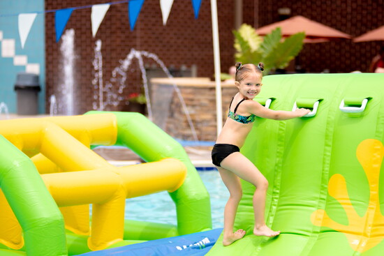 Child enjoying the pool at Coppermine. Photo Credit: Leah Rhianne for Coppermine