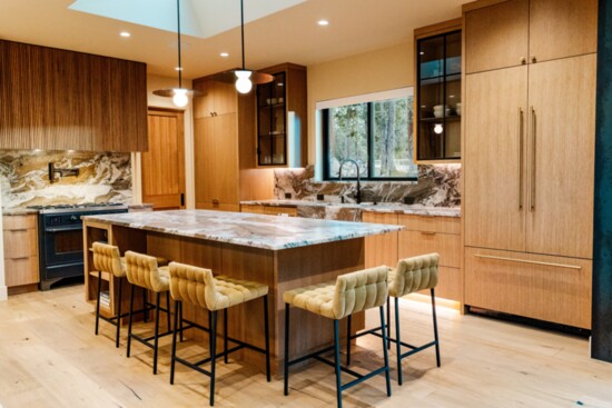 A high end custom kitchen with modern touches complements the cozy, rustic feel of this new home. 