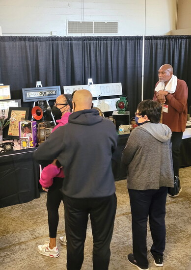 David McLucas looks on as exhibit attendees take it all in.