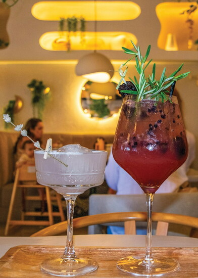 LUNA's Berry Spritz (right) bursts with muddled blackberries and rosemary, while a delicate lavender gin cocktail (left) adds a floral finish.