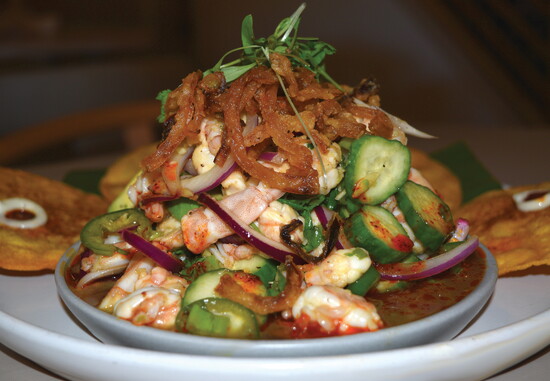LUNA's Ceviche Asiatico is a vibrant tower of shrimp, cucumbers, red onion, and crispy onion strings in a tangy soy-ponzu chili marinade.