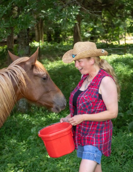 Rachel McAuley enjoys a moment with her rescue horse Liza.