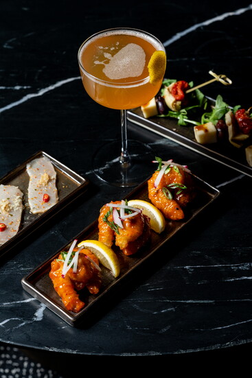 Collins Lobby Bar pairs elegant cocktails, live piano music, and plush seating for intimate, lingering evenings
