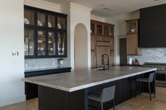 Alternating black and natural wood cabinets with Venaria Reale countertops and back splash provide clean new lines updating a tradition Mediterranean kitchen.