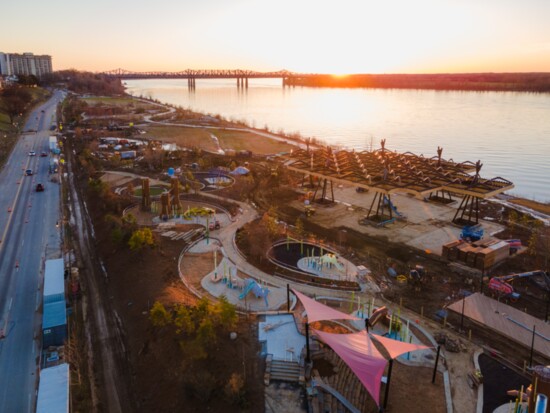 A southerly aerial view shows the scope of Tom Lee Park as the sun sets over the Mississippi