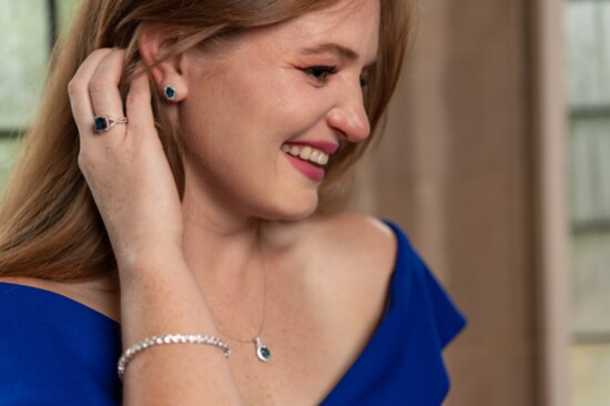Hallie Nelson, owner of Nelson Clothier, models jewelry designed by The Master Jeweler. 