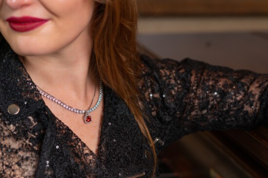 Hallie Nelson, owner of Nelson Clothier, models jewelry designed by The Master Jeweler. 