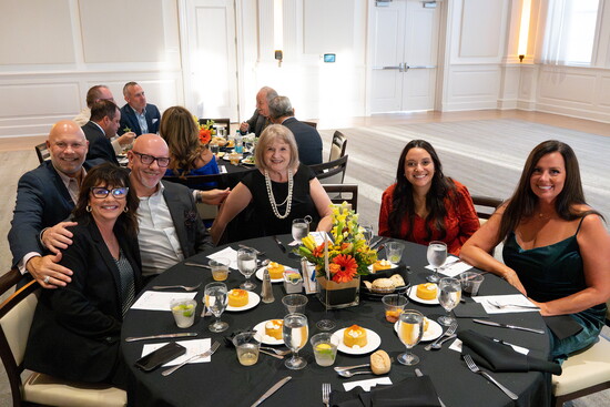 Industry professionals connecting over dinner and conversation